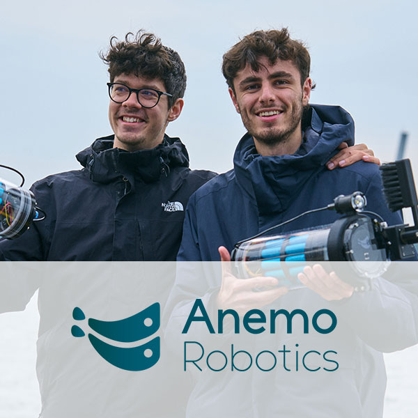 Two individuals in weatherproof jackets hold devices. A body of water is visible in the background. Anemo Robotics logo appears at the bottom.